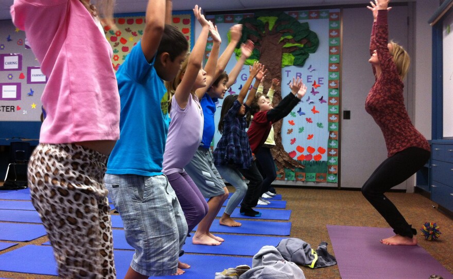 Third-graders at Olivenhain Pioneer Elementary School in Encinitas, Calif., perform chair pose with instructor Kristen McCloskey in December 2012.