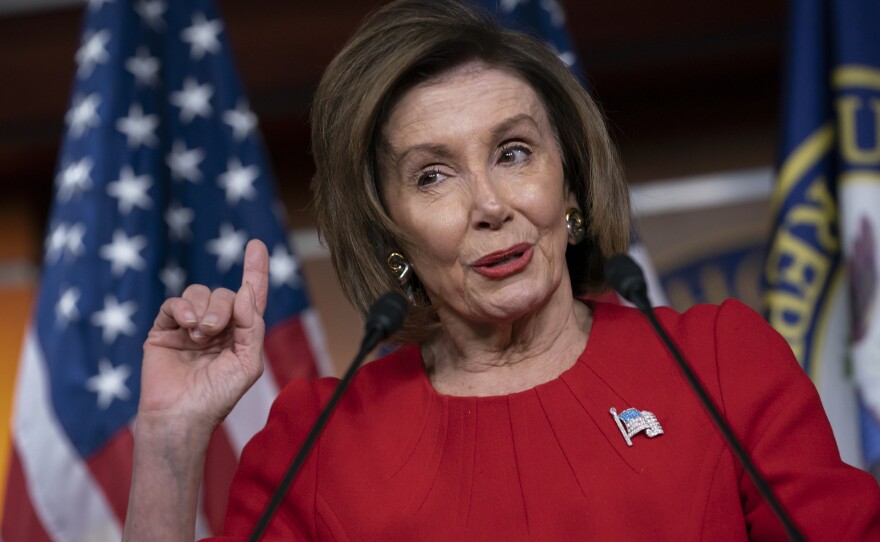 House Speaker Nancy Pelosi, D-Calif., talks to reporters after the first public hearing in the impeachment probe of President Trump. The House is looking into his effort to tie U.S. aid for Ukraine to investigations of his political opponents.
