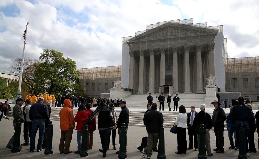 People line up to enter the Supreme Court building on April 22, when the court heard arguments in the <em>Agency for International Development v. Alliance for Open Society International</em> case.