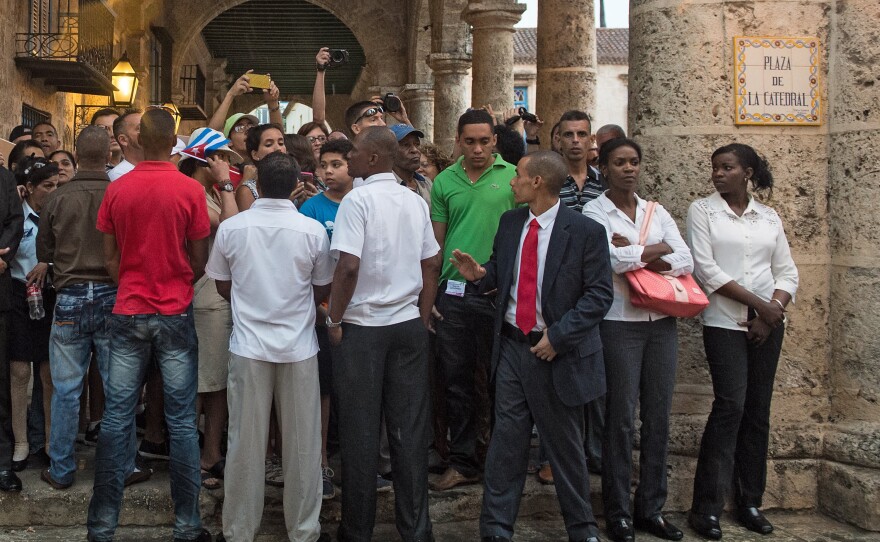 Cuban security agents keep watch as people wait for President Obama, first lady Michelle Obama and their daughters Malia and Sasha at the Catedral de los Angeles during the family's tour of Old Havana on March 20.