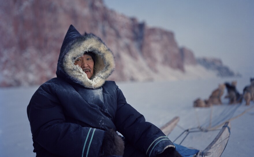 Peugatuk Ettuk, 63, drives his dog team on the sea ice near Arctic Bay. Like many Inuit in his age group, Ettuk grew up in a traditional outpost camp, living almost entirely off traditional foods, until he was pressured by the government to settle in Arctic Bay in his 20s. He was one of the last people in town to drive a dog team, preferring it over a snowmobile. He died in 2015.