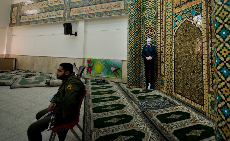 An image of Iranian Maj. Gen. Qassem Soleimani stands in the voting area in Razi school in north Tehran. The election is taking place less than two months after the U.S. carried out the targeted killing of the top military leader.