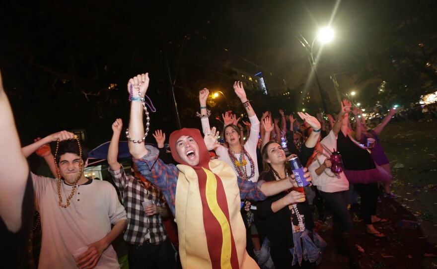 Sunday: Revelers yell for beads and trinkets.