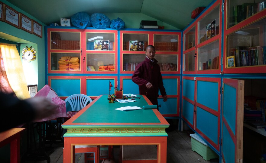 A student in the monastery school library. They study math, basic science and history as well as religion and language. The goal is to include climate change in future curricula.