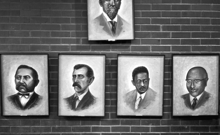 Portraits of the mayors of Mound Bayou, Miss., an early autonomous African-American community, hang inside the Mound Bayou City Hall, in September 2009. The top portrait is Mound Bayou's founder, Isaiah T. Montgomery.