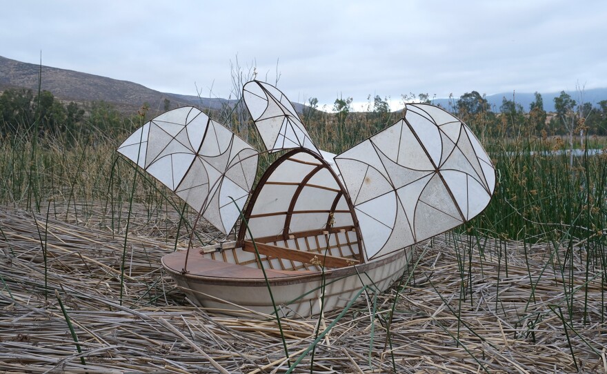 MH-1 is a work of wood, steel, and waterproof, paper-like casing that floats or can be pulled by bicycle.