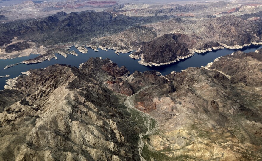 In this aerial photo, a bathtub ring of light minerals show the high water mark on the shore of Lake Mead along the border of Nevada and Arizona, Monday, March 6, 2023, near Boulder City, Nev. The federal government is expected to make an announcement on Tuesday, Aug. 15, 2023, about the health of the Colorado River and water cuts in 2024.