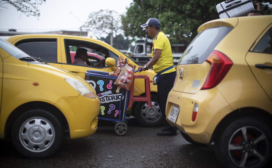 A man sell snacks in traffic in the border town of Villa del Rosario, near the Simón Bolívar bridge.