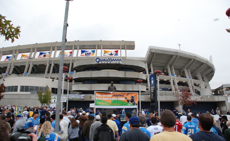 Fans walk into Qualcomm Stadium.