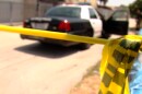 An undated file photo of a crime scene police tape and a San Diego Police Department cruiser in the background.