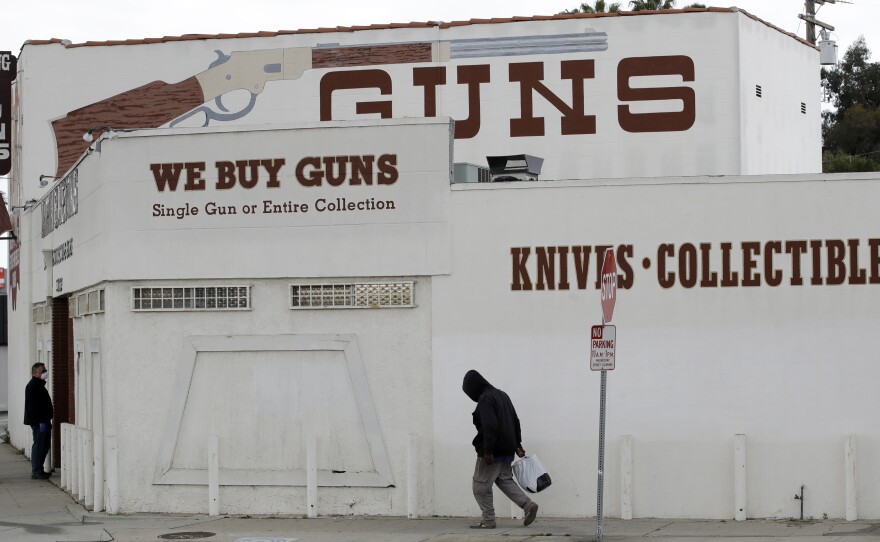 Guns are advertised for sale at a shop on Tuesday in Culver City, Calif. Los Angeles County Sheriff Alex Villanueva said he would like to see gun shops shut down.