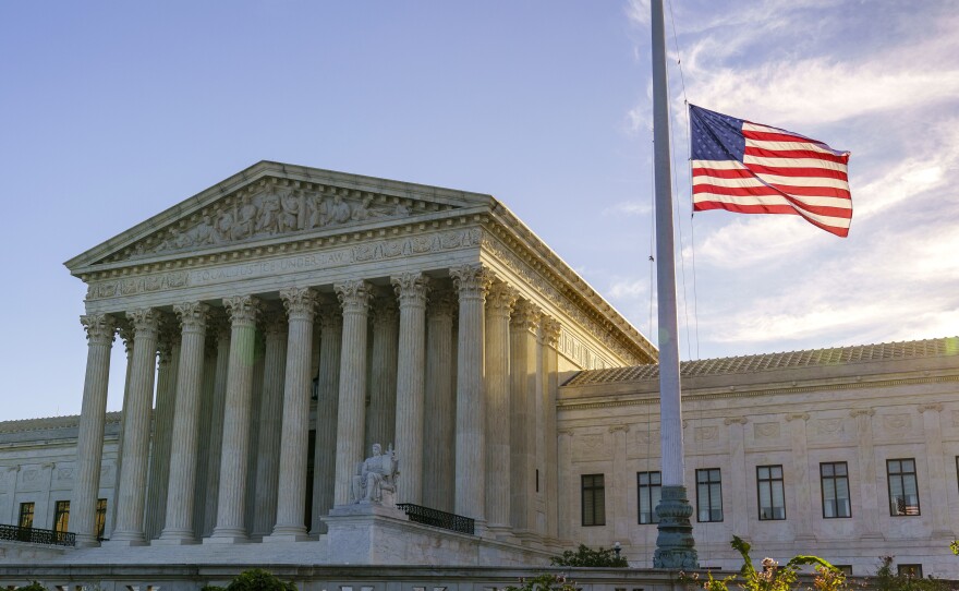 The flag flies at half-staff Saturday at the Supreme Court on the morning after the death of Justice Ruth Bader Ginsburg.