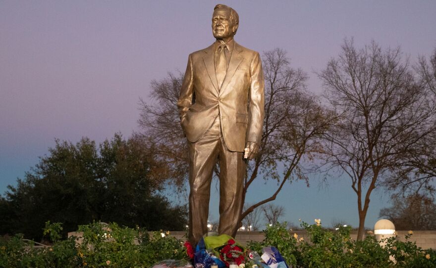 Flowers are laid at the base of the statue at the George Bush Presidential Library and Museum in College Station, Texas.
