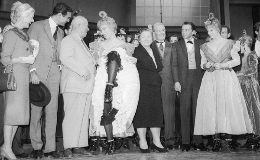 Shirley MacLaine performs like a Can Can girl for Soviet Premier Nikita Khrushchev at the 20th Century Fox Studios. Left to right: Louis Jourden, Mr. Khrushchev, Shirley MacLaine, Mrs. Khrushchev, Maurice Chevalier and Frank Sinatra.