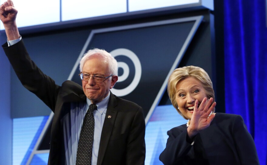 Bernie Sanders and Hillary Clinton stand together Wednesday before the start of the Democratic presidential debate at Miami Dade College in Miami.