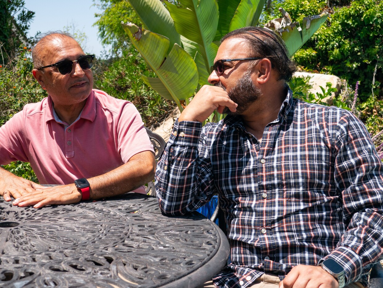 Homayoun and Shafiq Siddiq chat in their backyard on May 1, 2026.