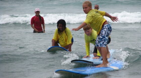 Military kids learning to surf at a Camp Yellow Ribbon.