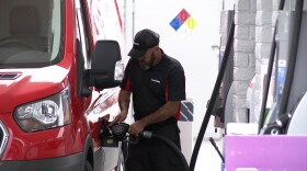 A deliver driver pumps gas at at a gas station on Park Boulevard in University Heights on March 31, 2026.