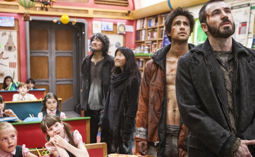 Wealthy children inhabiting the front of the train are offered luxuries such as education, while those who dwell in back, (from right) Curtis (Chris Evans), Grey (Luke Pasqualino), Yona (Ah-sung Ko) and Namgoong Minsoo (Kang-ho Song), live in squalor.