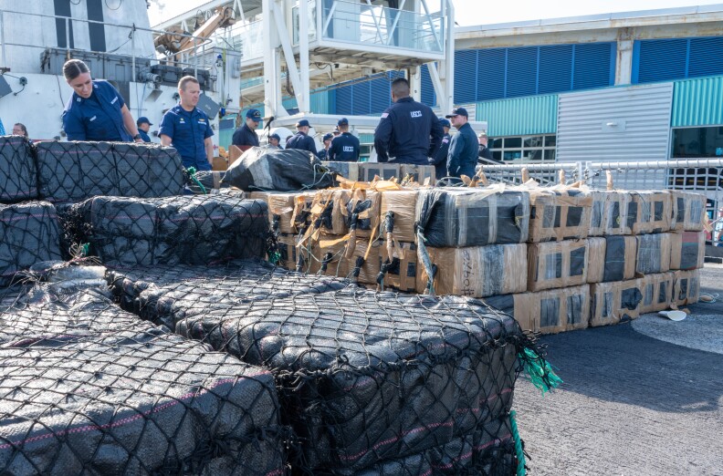 Crew members from the U.S. Coast Guard Cutter Steadfast (WMEC 623) stack interdicted, illegal drugs on the flight deck of the cutter as they prepare to offload in San Diego, July 17, 2023.