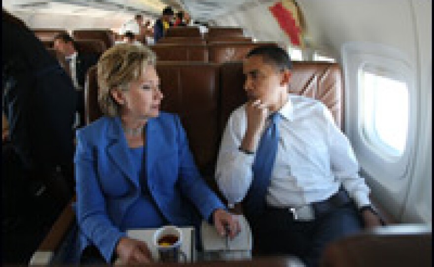 Illinois Sen. Barack Obama and New York Sen. Hillary Rodham Clinton talk onboard Obama's campaign plane on June 27, 2008, en route to New Hampshire.