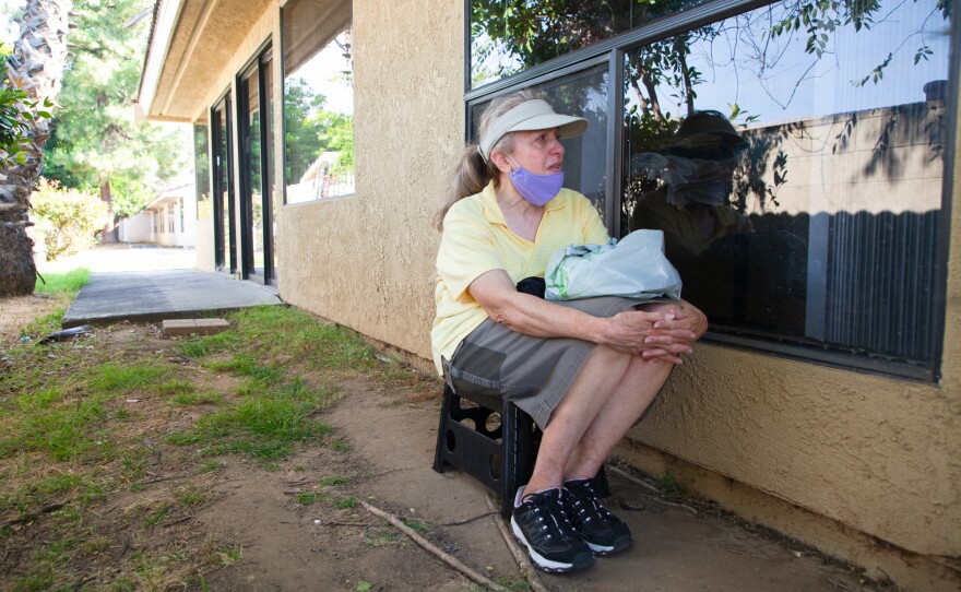 Rosa Montiel sits outside of her sister Lilly's window at San Diego Post-Acute, an El Cajon nursing home, June 10, 2020.