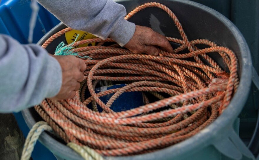 Ogg stows rope aboard his boat, the Karen Jeanne, in Bodega Bay, March 3, 2023.