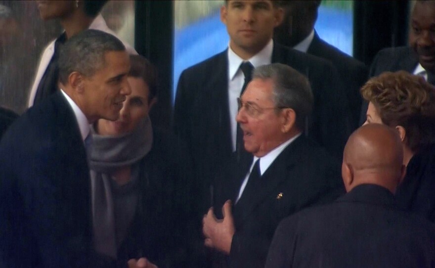 In this image from TV, President Obama shakes hands with Cuban President Raul Castro at the memorial service for former South African leader Nelson Mandela in Soweto in December 2013. It was reported to be just the second handshake between leaders of the two countries in 50 years.