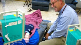 Nurse practitioner Scott Shuford tries to lighten the mood with his patients at the San Diego Cancer Center in Vista. Shuford says it's tough when he has to change their chemotherapy because of a shortage of certain drugs.