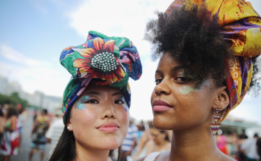Women strike a pose during an International Women's Day march last year in Rio de Janeiro.