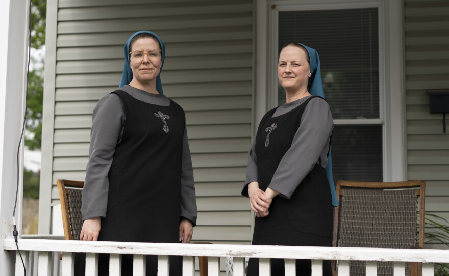 Sister Danielle Lussier and Sister Theresa Alethia pose for a portrait on the front porch of their home in Mt. Sterling, Ky., in April.