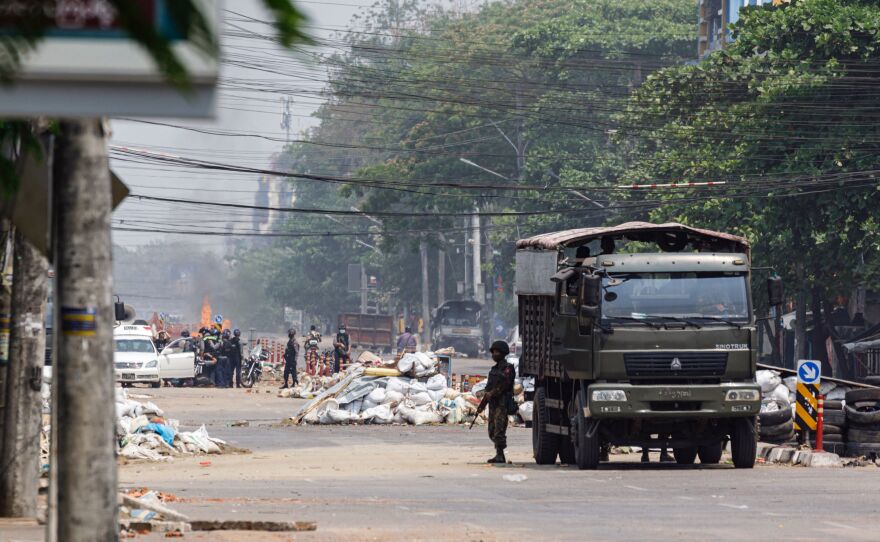 Security forces stand guard on a road as people are arrested, next to dismantled barricades that were set up by protesters demonstrating against the military coup, in Yangon, Myanmar, on Friday.