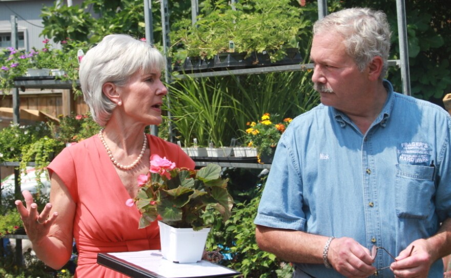 Health and Human Services Secretary Kathleen Sebelius talks about insurance with Nick Kaplanis, manager at Frager's Hardware Store, Washington, D.C.