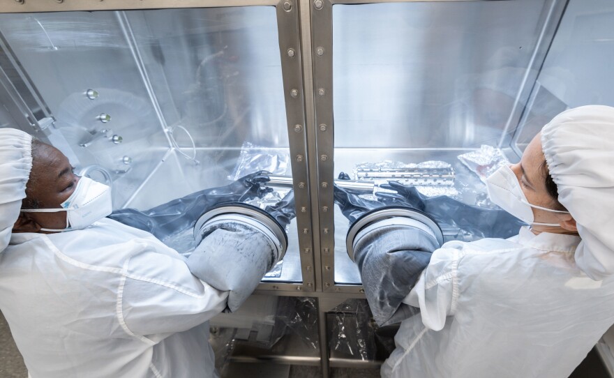 Scientists work on gas extraction from an Apollo 17 lunar sample last month at NASA's Johnson Space Center in Houston.