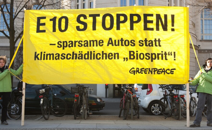 Greenpeace activists display a banner reading: "Stop E10! Fuel-efficient cars instead of harmful biofuel!" outside the economy ministry in Berlin on March 8. The ministry was holding an E10 biofuel summit that day.