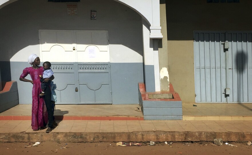 A woman looks down an empty street Wednesday in Banjul, Gambia, hours before the end of longtime leader Yahya Jammeh's mandate.