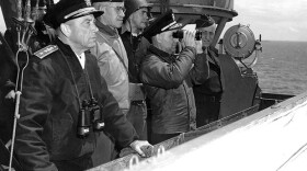 Normandy Invasion, June 1944. Senior U.S. officers watching operations from the bridge of USS Augusta (CA-31), off Normandy, June 8, 1944. They are (from left to right): Rear Admiral Alan G. Kirk, USN, Commander Western Naval Task Force; Lieutenant General Omar N. Bradley, U.S. Army, Commanding General, U.S. First Army; Rear Admiral Arthur D. Struble, USN, (with binoculars) Chief of Staff for RAdm. Kirk; and Major General Hugh Keen, U.S. Army.
