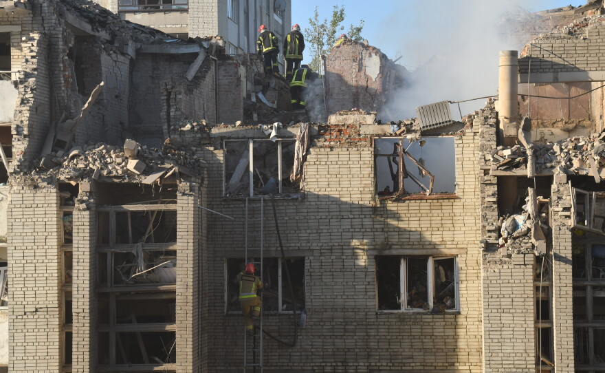 Rescuers search through the rubble of a residential building following air attack in Lviv, Ukraine, Thursday, July 30, 2026.