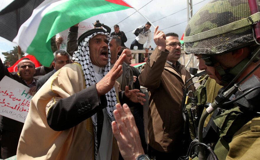 A Palestinian dressed in traditional robes confronts an Israeli soldier during a small protest near the Jewish settlement of Kiryat Arba, just outside the West Bank city of Hebron, on March 30. The protest commemorates Land Day, when six Israeli-Arabs were killed in 1976 during marches against land confiscation in the northern Galilee region of Israel.