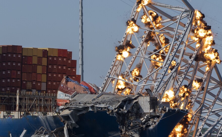 Explosive charges are detonated to bring down sections of the collapsed Francis Scott Key Bridge resting on the container ship Dali on Monday in Baltimore.