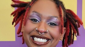 Woman smiling at camera with vibrant background