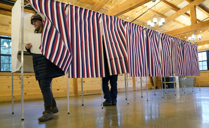 A voter leaves a voting booth in Concord, N.H., the during primary election on Jan. 23, 2024.