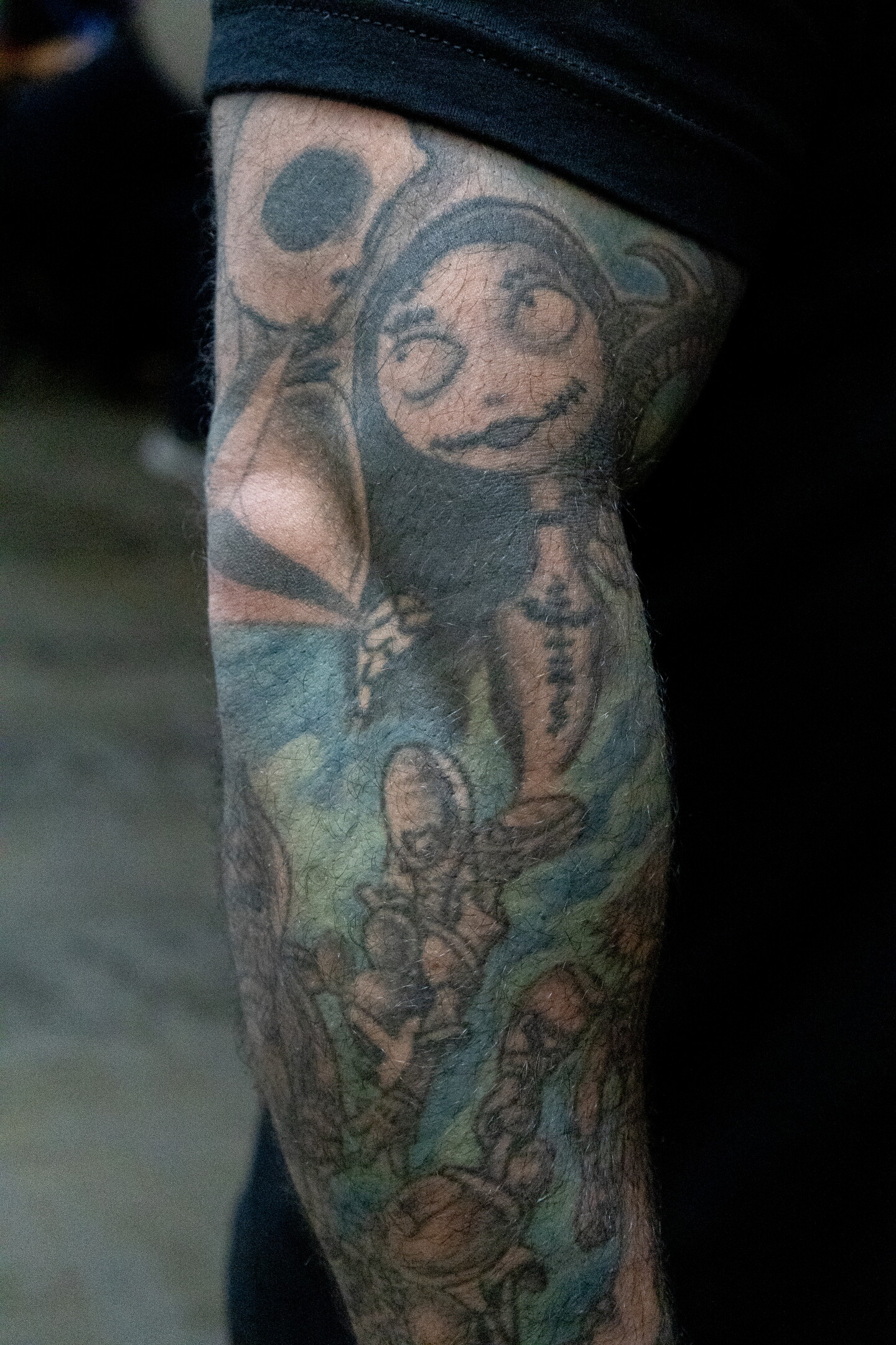 A Jack Skellington and Sally tattoo hugs around the elbow of a convention attendee at Comic-Con, July 23, 2026.