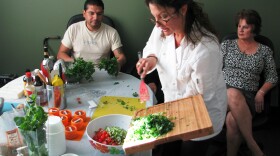 Chef Palma Bellinghieri chops fresh vegetables for a tabouli salad. She believes eating the right foods can help reduce chronic pain.