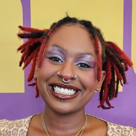 Woman smiling at camera with vibrant background