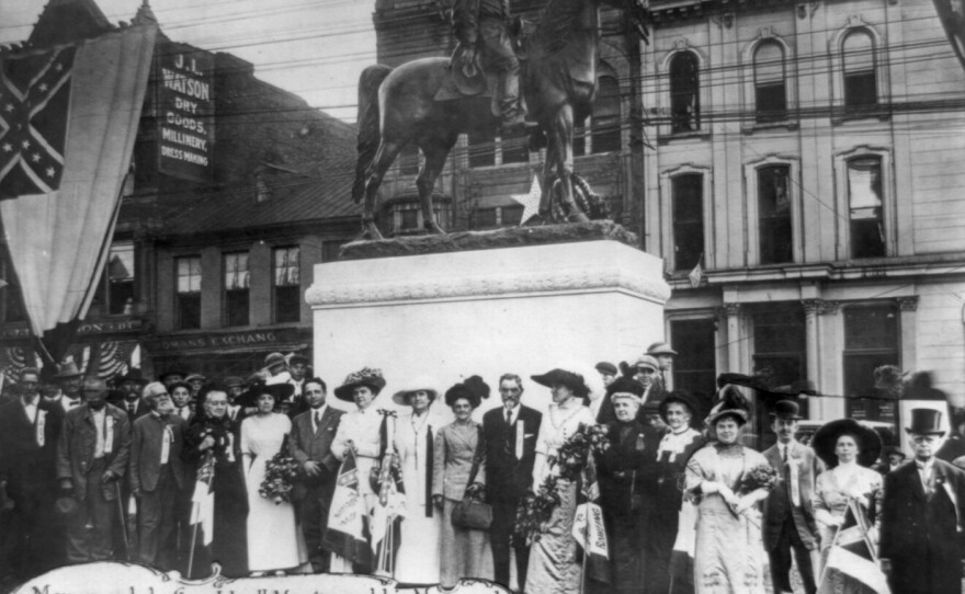 Members of the United Daughters of the Confederacy stand in front of a monument they commissioned of Confederate Gen. John Hunt Morgan and his men in Lexington, Ky., in 1911. The group has put up more than 600 markers and monuments to the Confederacy nationwide.
