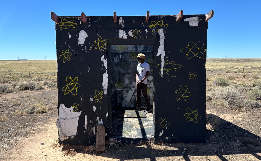 Chip Thomas stands in the middle of an abandoned cinder block building north of Flagstaff, Az. The structure holds a sight and sound installation, spotlighting the devastating health effects of uranium mining among Navajo workers during the cold war.