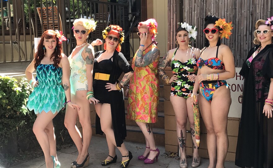 Tiki Oasis attendees pose for a photo in their swimsuits, August 8, 2019.