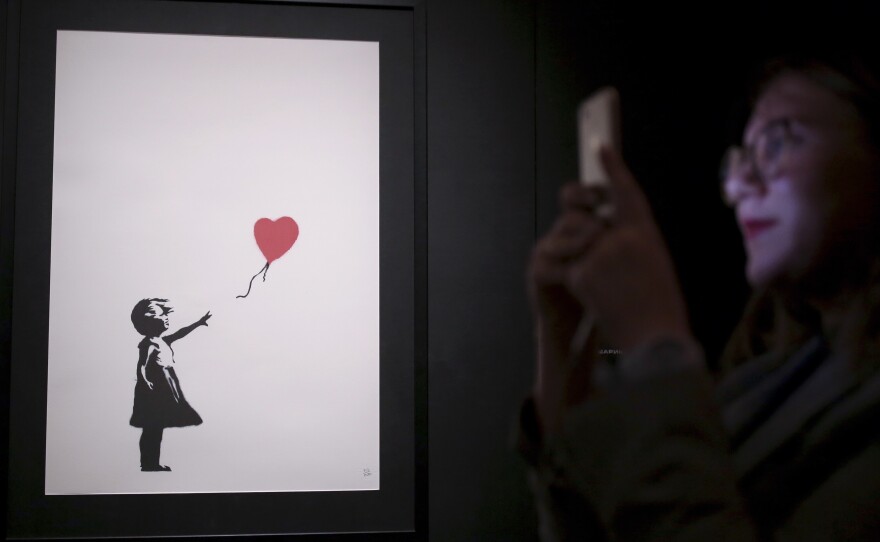 One of Banksy's "Girl With Balloon" paintings is on display at an exhibition opening of works by the England-based street artist, at St. Petersburg's Manege Central Exhibition Hall in September.