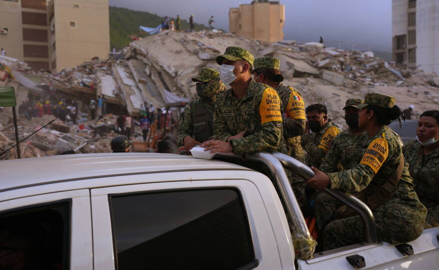 Venezuelan firefighters and volunteers search for possible victims atop a collapsed building in Caraballeda, La Guaira state, Venezuela, on Saturday, June 27, 2026.